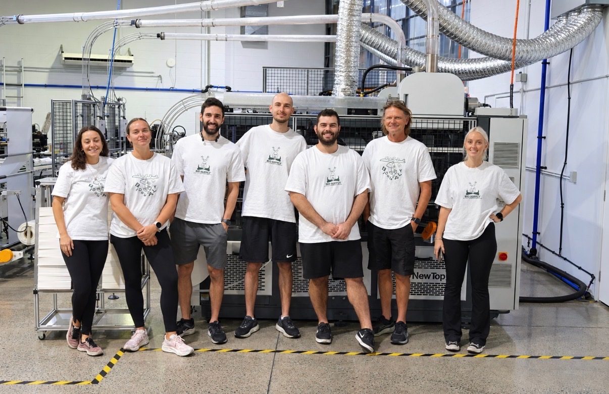The bioSupply team on the factory floor in front of the cup press in Nerang, Queensland